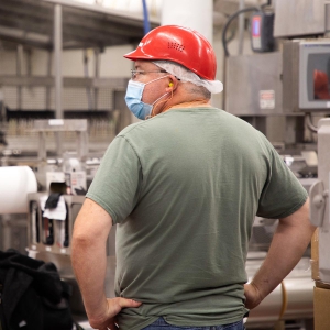 Photo of Employee in Warehouse Wearing a Face Mask